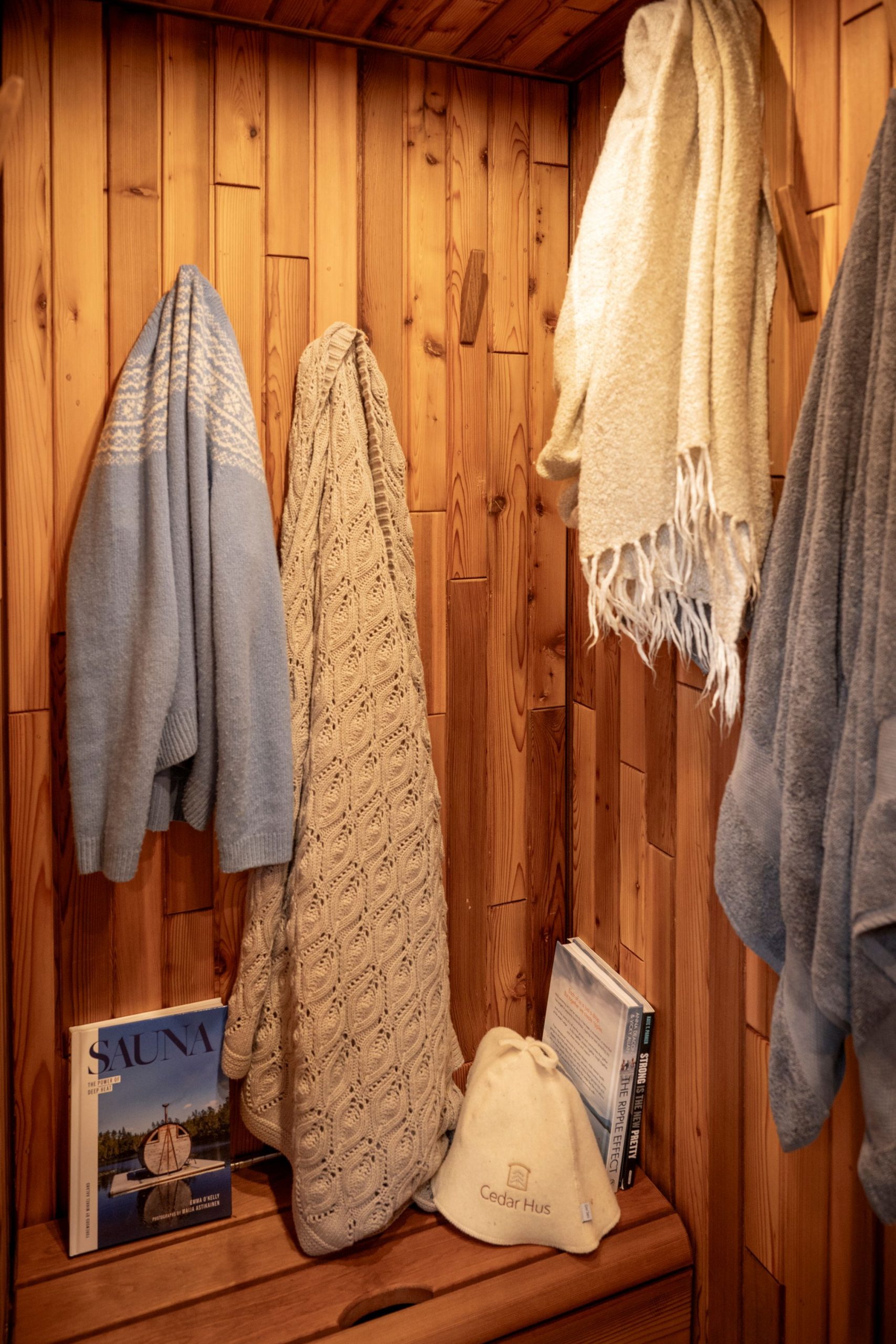 Sauna changing room with hooks full of clothes